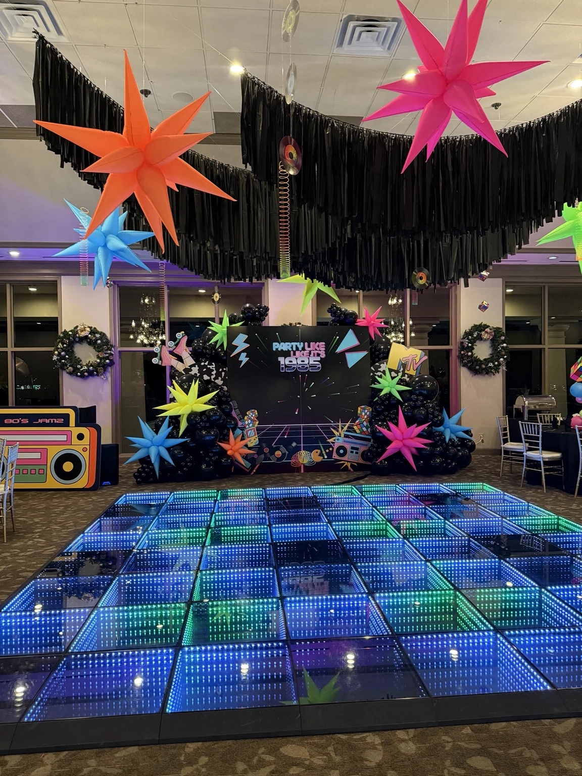 Completed Party Like It’s 1985 backdrop and glowing dance floor