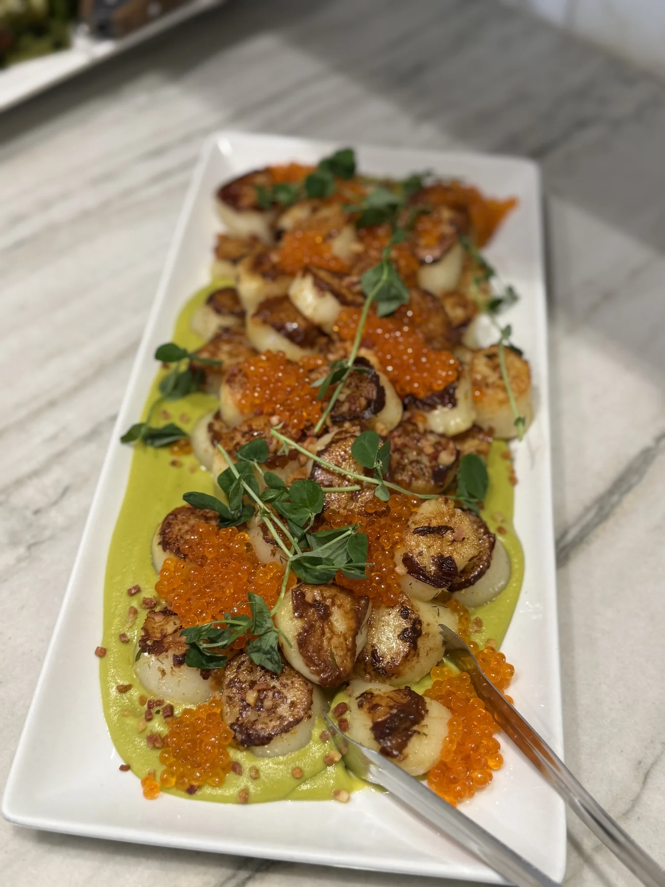 A plated scallop course