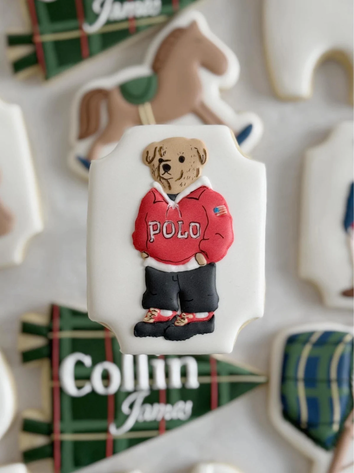 Close-up of a custom teddy-bear cookie in a red polo shirt