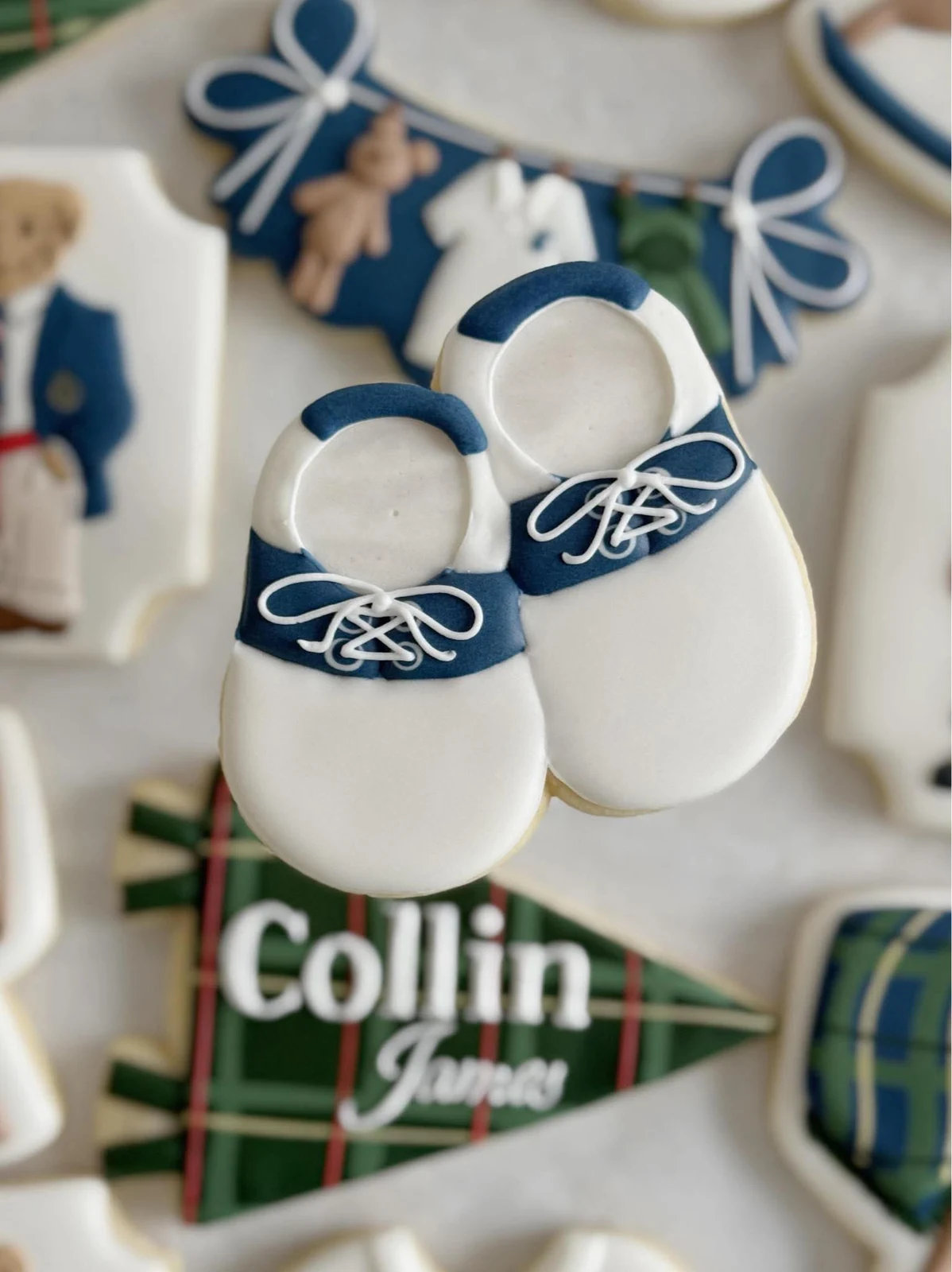 Close-up of custom blue baby-shoe cookies