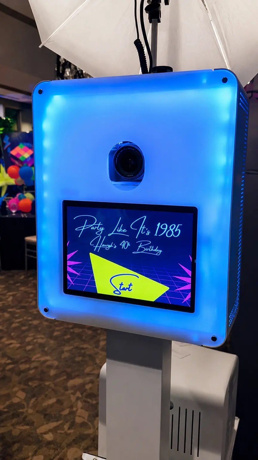 The neon-lit photo booth with a custom Party Like It’s 1985 screen