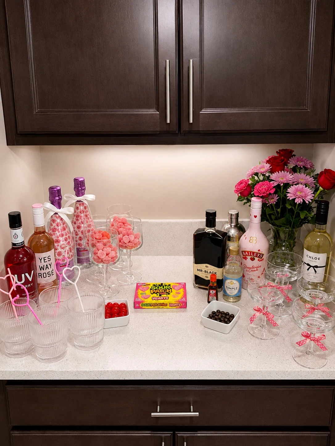 Galentine’s cocktail and candy station with red and pink styling