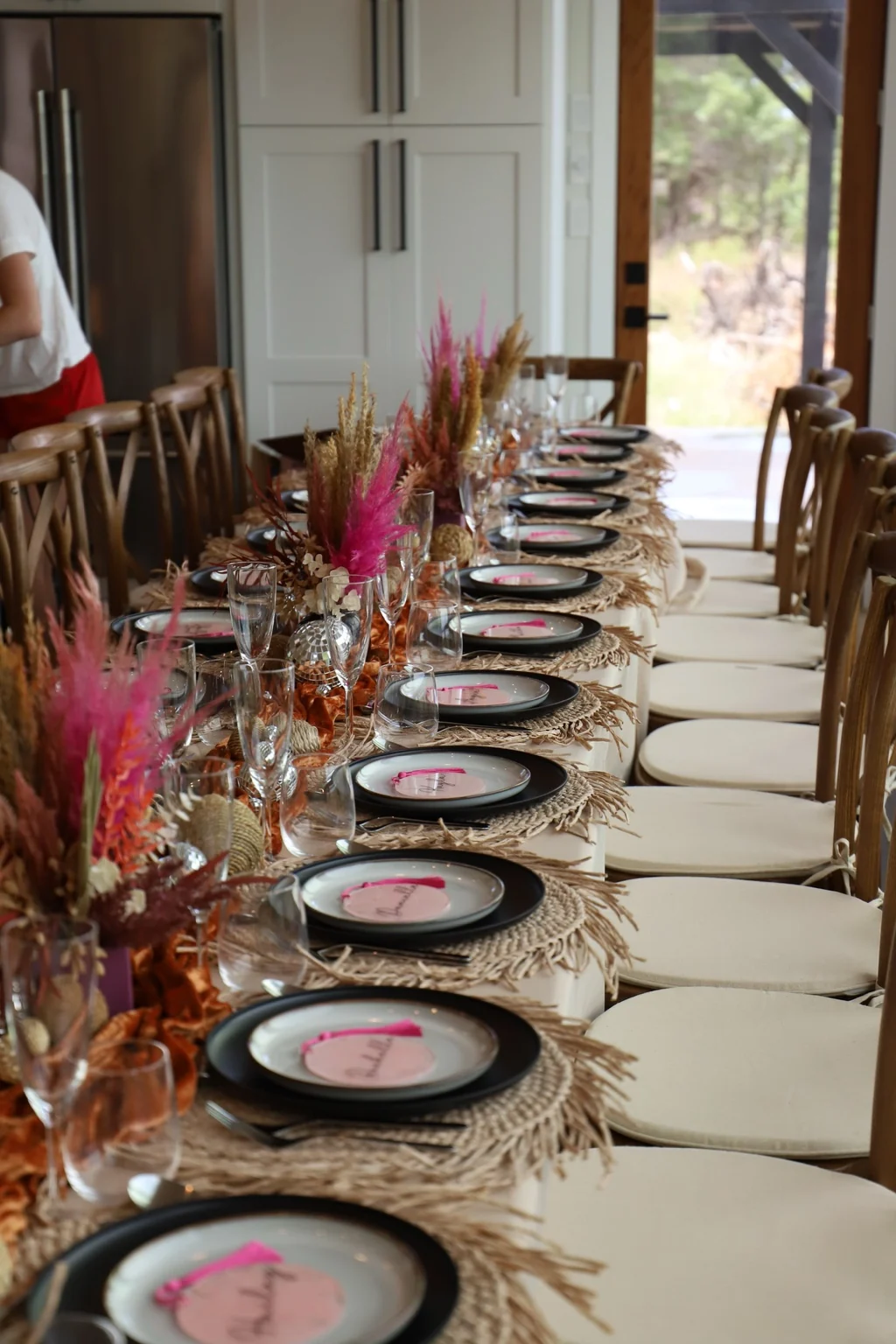 A long event tablescape with pink, burgundy, and disco-inspired details