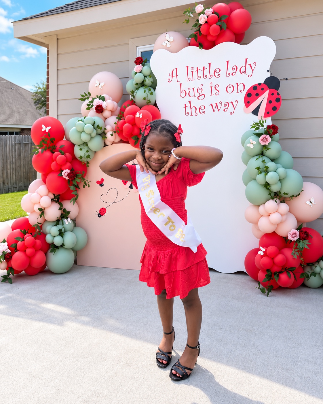 Big sister posing in front of the ladybug backdrop