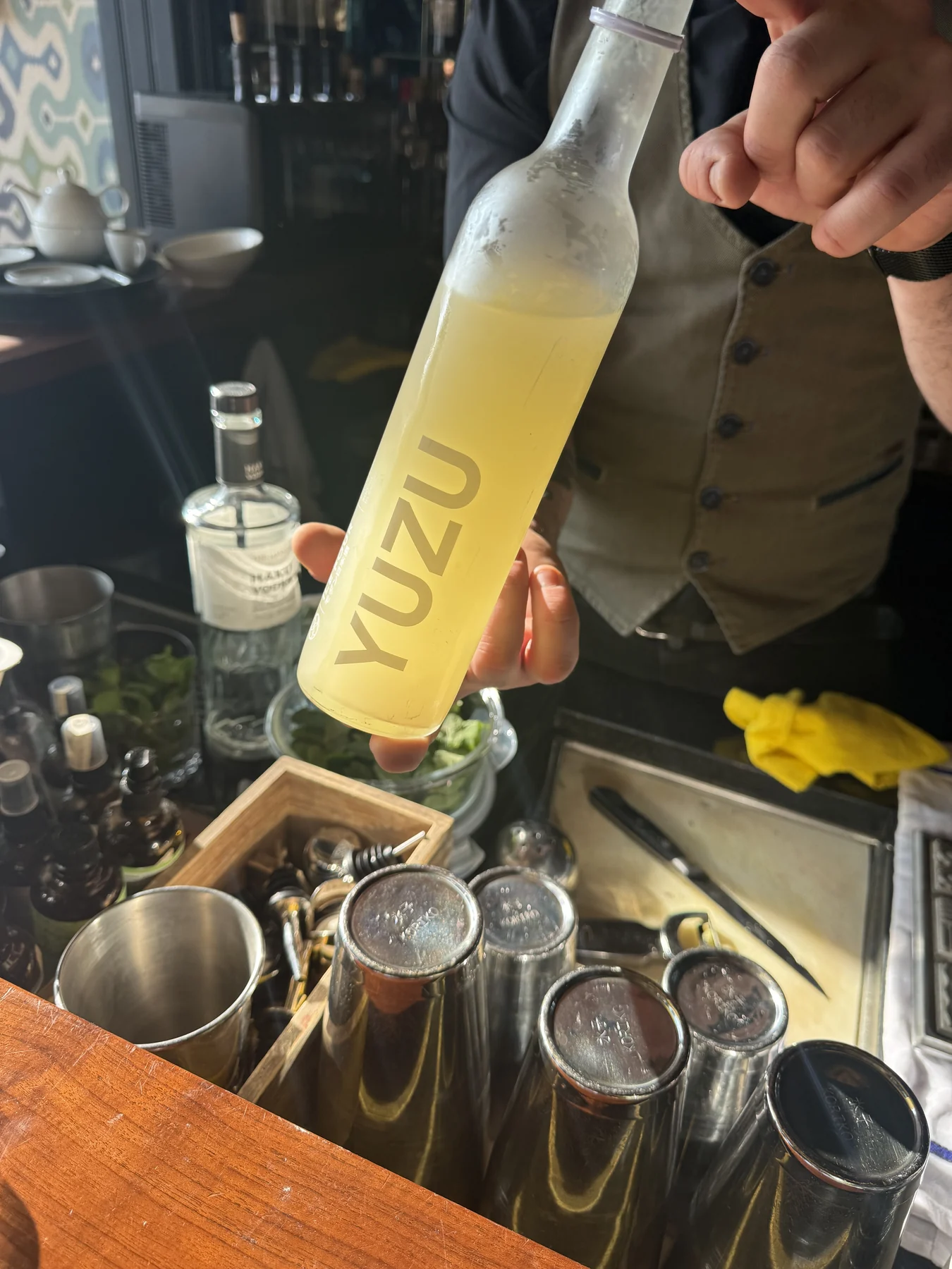 A yuzu bottle being poured at the bar in Lucerne